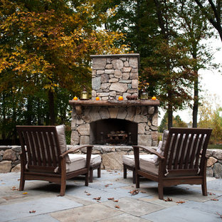 Elegant patio photo in Boston with a fire pit