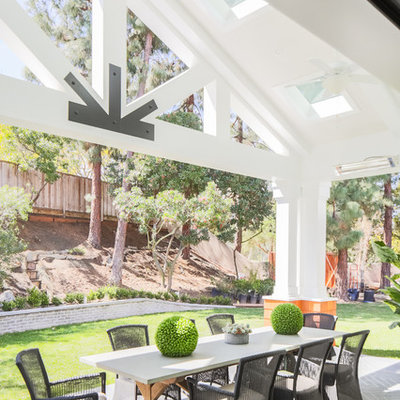 Transitional backyard patio photo in Orange County with a roof extension