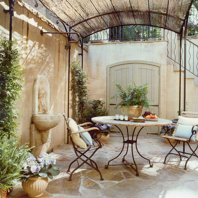 Tuscan stone patio fountain photo in DC Metro with a pergola