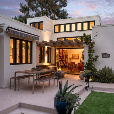 Inspiration for a mid-sized mediterranean backyard concrete patio remodel in Santa Barbara with a fire pit and a pergola