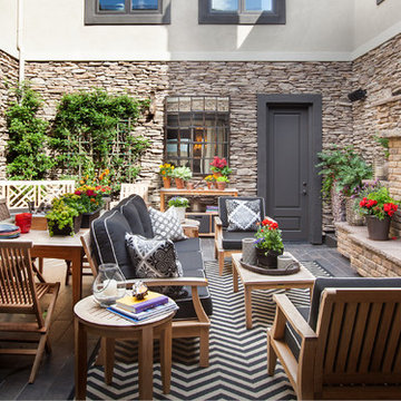 Transitional Stone Courtyard with Brick Fireplace