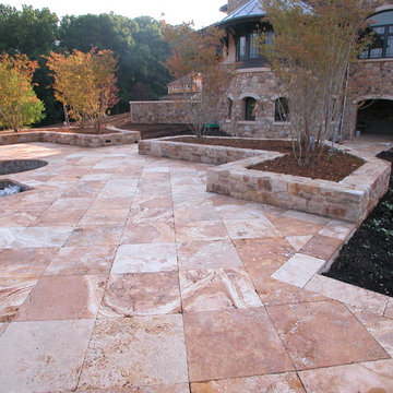 Travertine flatwork with granite planters at this new pool patio.