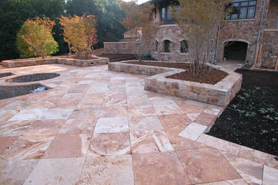 Travertine flatwork with granite planters at this new pool patio.