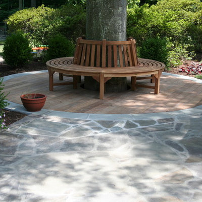 Example of a trendy backyard stone patio design in DC Metro