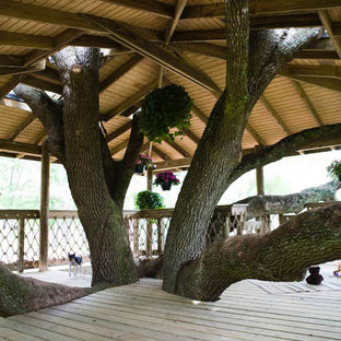 Example of a huge classic backyard patio design in New Orleans with a pergola