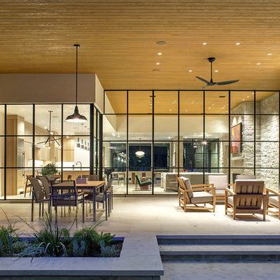 Inspiration for a large contemporary backyard tile patio kitchen remodel in Austin with a roof extension