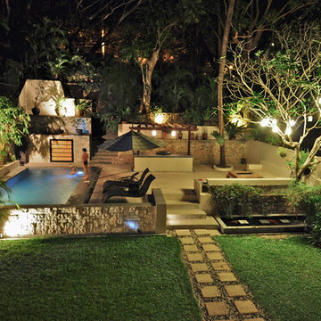 Tropical garden with swimming pool and patio