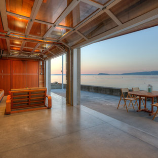 Patio kitchen - small contemporary backyard concrete patio kitchen idea in Seattle with a roof extension
