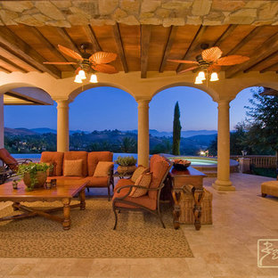 Large tuscan backyard tile patio photo in Los Angeles with a fire pit and a roof extension
