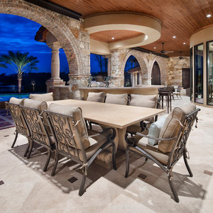 Inspiration for a mediterranean backyard patio kitchen remodel in Houston with a roof extension