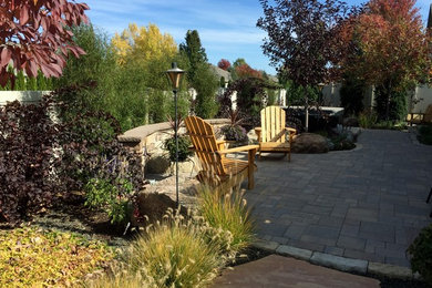 Example of a small classic backyard concrete paver patio fountain design in Boise with no cover