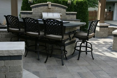 Patio kitchen - large traditional backyard brick patio kitchen idea in Chicago with a pergola