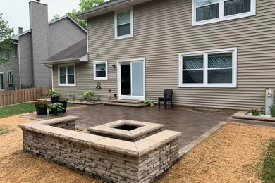 Mid-sized minimalist backyard brick patio photo in Chicago with a fire pit