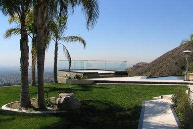 Inspiration for a mid-sized contemporary backyard tile patio remodel in Los Angeles with no cover