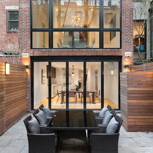 Mid-sized minimalist backyard concrete paver patio photo in New York with no cover