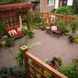 Patio - small traditional backyard brick patio idea in Chicago with a pergola