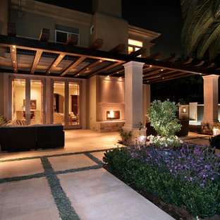 Inspiration for a mediterranean backyard stone patio remodel in Orange County with a fire pit and a pergola