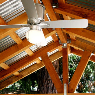 Inspiration for a small industrial backyard patio remodel in Sacramento with a pergola