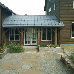Idee per un ampio patio o portico country in cortile con ghiaia e un tetto a sbalzo