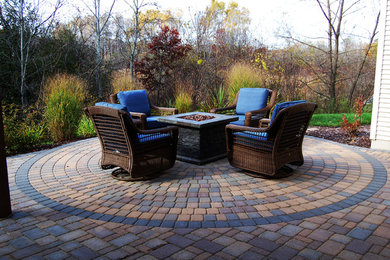 Mid-sized mountain style backyard concrete paver patio photo in Minneapolis with a fire pit and no cover
