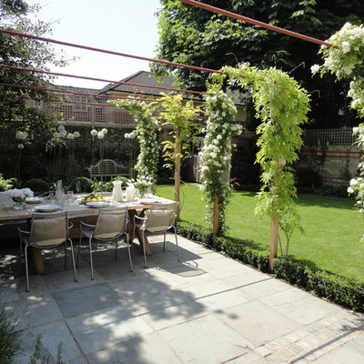 Patio - mid-sized contemporary backyard patio idea in London with no cover