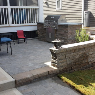 Inspiration for a small transitional front yard concrete paver patio kitchen remodel in Raleigh with no cover