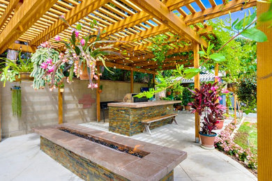 Example of an island style patio design in Orange County