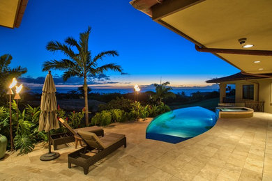 Patio - large tropical backyard tile patio idea in Hawaii with a fire pit and a roof extension