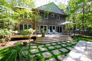 Example of a mid-sized minimalist backyard patio design in New York with decking