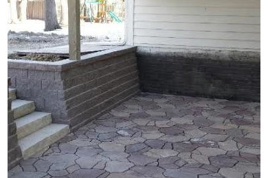 Patio - mid-sized transitional backyard stone patio idea in Other