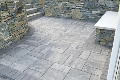 Design ideas for a medium sized classic back patio in Boston with natural stone paving and no cover.