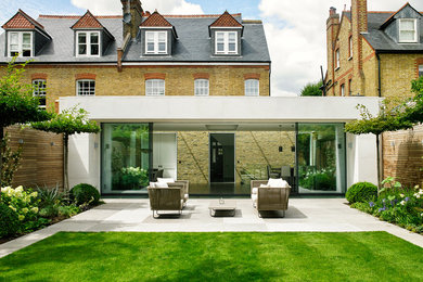 Inspiration for a medium sized contemporary back patio in London with no cover and concrete paving.
