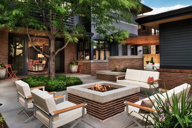 Inspiration for a contemporary patio remodel in Denver with a fire pit and no cover