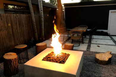 Patio - small modern backyard patio idea in Denver with a fire pit and no cover