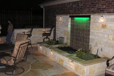 Patio fountain - mid-sized contemporary backyard patio fountain idea in Dallas with no cover