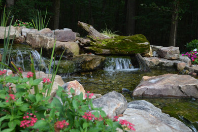 This is an example of a large traditional backyard water fountain landscape in Charleston.