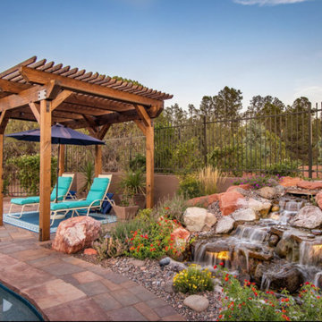 Waterfall by Pond. Pergola Covered Seating Area
