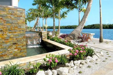 Example of an island style patio design in Tampa