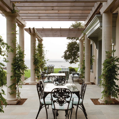Patio - mediterranean patio idea in New York with a pergola