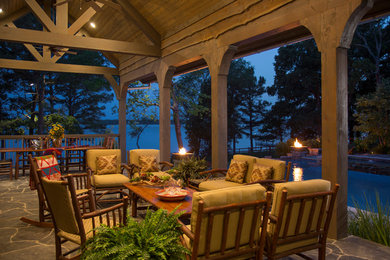 Inspiration for a large timeless backyard stone patio remodel in Austin with a pergola and a fire pit