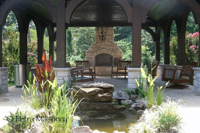 Patio - mid-sized traditional backyard stone patio idea in St Louis with a fire pit and a gazebo