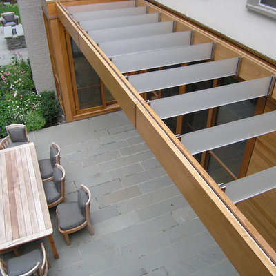 Inspiration for a contemporary patio remodel in Boston with a pergola