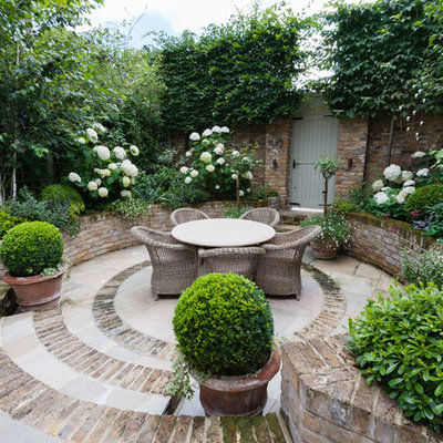 Patio - small traditional brick patio idea in London