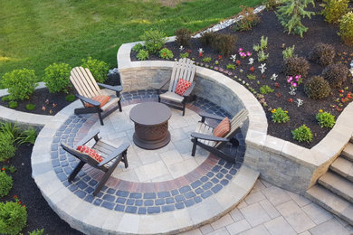 Inspiration for a huge timeless backyard concrete paver patio remodel in Philadelphia with a fire pit and no cover