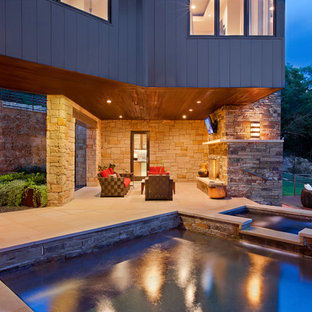 Patio - contemporary backyard patio idea in Austin with a fire pit and a roof extension