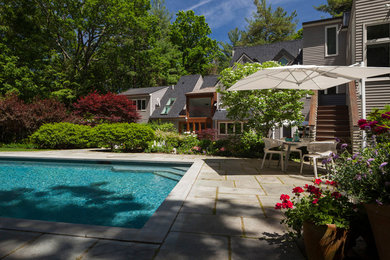 Huge transitional backyard stone patio photo in Boston with no cover