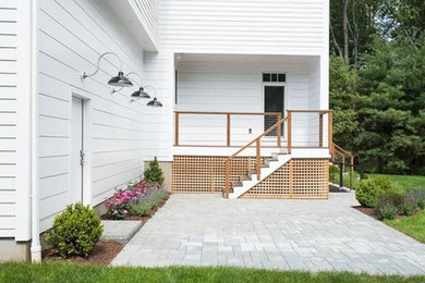 Example of a mid-sized transitional backyard concrete paver patio design in New York
