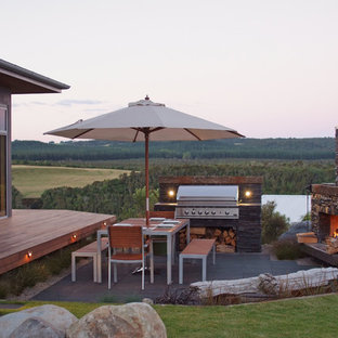 Photo of a small contemporary side yard patio in Auckland with no cover, concrete pavers and with fireplace.