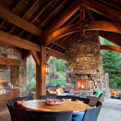 Inspiration for a rustic patio remodel in Other with a roof extension