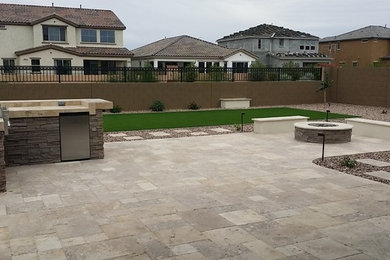 Mid-sized elegant backyard stone patio kitchen photo in Phoenix with no cover
